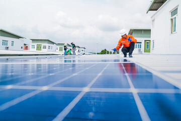 engineer man inspects construction of solar cell panel or photovoltaic cell by electronic device. Industrial Renewable energy of green power. factory worker working on tower roof.