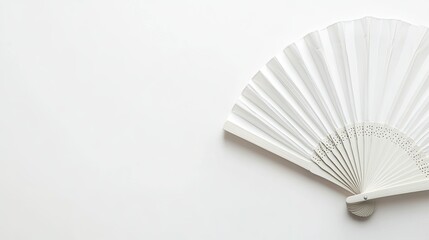 Flat lay of a traditional white folding fan, isolated on a clean white background with space for design.