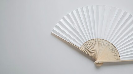 Flat lay of a traditional white folding hand fan, isolated on a white background, ideal for product design.