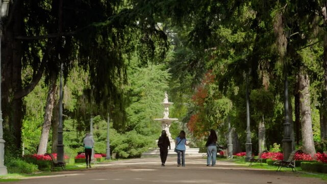 Tourist and runners in park, Madrid, Spain at noon