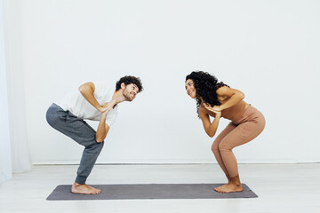 Obraz premium Man and woman doing yoga exercises meditation asana pose