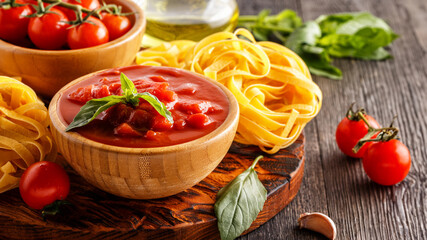 Products for cooking - tomato sauce, pasta, tomatoes, garlic, olive oi.