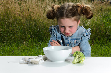 The kid girl is refusing to eat.