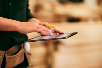 Carpenter, hands and tablet in workshop for design, creative woodwork and stock check. Carpentry,...