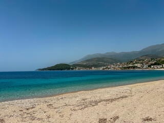 Panoramic view of the picturesque coastline of coastal tourist town Himare, Vlore, Albania. Sand beach Potami with scenic vistas of majestic mountains of Karaburun-Sazan Marine Park. Summer vacation