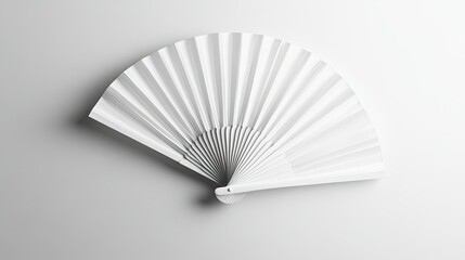 Minimalistic display of a classic white folding hand fan, laid flat against a seamless white background.