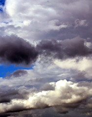 Fluffy White Clouds in a Blue Sky as A Skyscape Background
