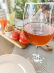 glass of rose or blush wine over starter plate on table