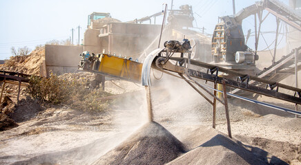 Vibrating screen stone crusher in operation. Crushing stones in a quarry for processing minerals,...