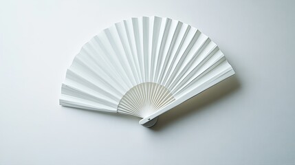 Overhead view of a sleek white folding fan, isolated on a plain white surface with pleats fully extended.