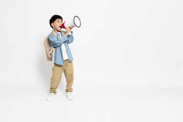 Asian little boy holding megaphone and carries a backpack to school in casual clothes isolated on white background, Back to school or  extra classes concept