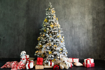 Snow Christmas tree with gifts in the interior of a decorated gray room