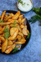  Home made Wedges spicy Potatoes and fresh  lemon on wooden background