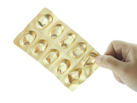 Female hand holding tablets that have been taken isolated on transparent background.
