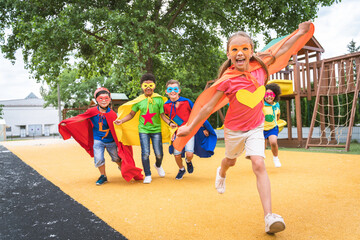 Group of young schooler wearing superhero costumes