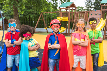 Group of young schooler wearing superhero costumes
