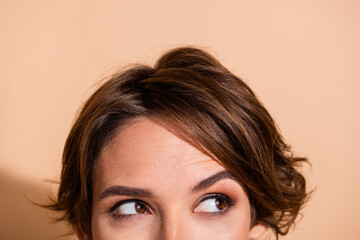 Cropped photo portrait of pretty young girl hide face look cunning empty space isolated on beige...