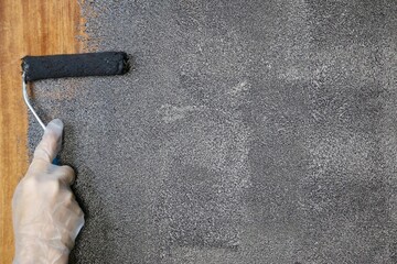 Updating an old furniture. DIY. Repainting an old wooden cabinet in a new black color close up.