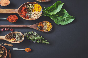 Kitchen, spices and spoon on counter for culinary ingredients, flavor and seasoning with leaves for cooking. Seeds, rosemary and above table for meal prep, herbs and variety for food at restaurant