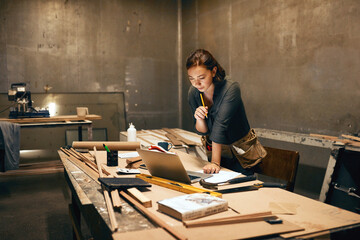 Woman, wood or thinking at workshop laptop for planning, design process or contact at night....