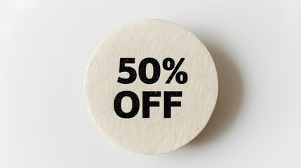 Black '50% OFF' Text on a White Round Paper Note. White Background with Copy Space