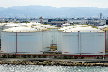 White tanks in tank farm, big silos, tall metal tanks, multiple steel tanks to storage oil products