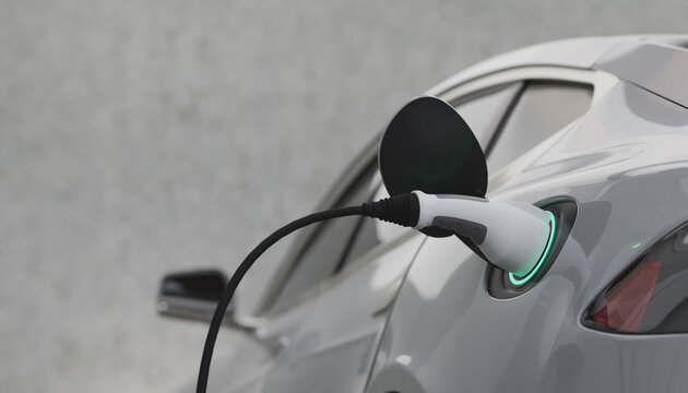 Electric Car Charging At Power Station with blurred wall  on background.