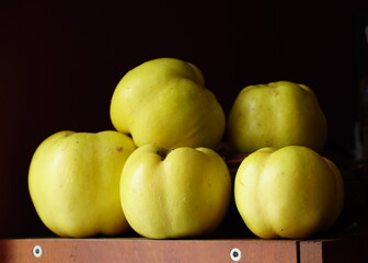 yellow quinces on a shelf