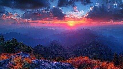 This breathtaking image captures the stunning beauty of a mountainous landscape at sunset. The sky is painted with vibrant colors ranging from deep blues to fiery oranges