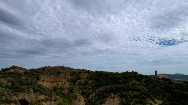 4K Aerial drone video of ancient town elevated in the hills with unreal cloud shapes with a mystical look. Abandoned ghost town Tursi in Italy outback with empty houses and streets
