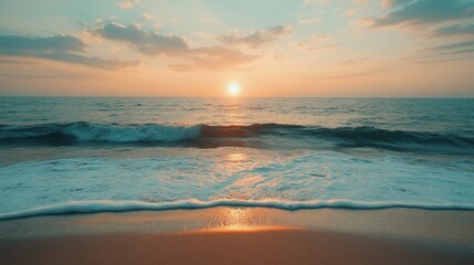 Obraz premium A tranquil evening scene of Marina Beach, with the sun setting over the horizon, casting a warm glow on the sand and water.