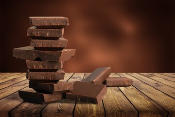 Broken dark sweet chocolate bar on desk