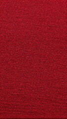 Fototapeta premium The texture of red fabric with a fine pattern creating the effect of depth and richness. Suitable for backgrounds, wallpapers and design projects