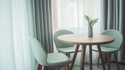 Two mint color chairs at round wooden dining table against window dressed with grey and white curtains. Scandinavian interior design of modern dining room