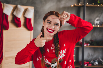 Portrait of nice young woman show cadre gesture toothy smile wear sweater new year x-mas time flat indoors