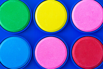 Colorful watercolors close-up shot. Brand new watercolors. Education, art, painting, new beginning concept.