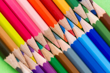 Fototapeta premium Coloring pencil tips geometric arrangement. Diagonal geometric coloring pencils close-up.