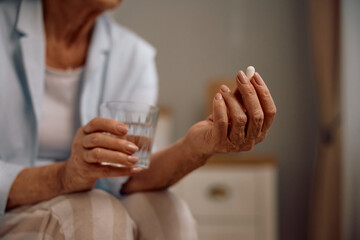 Close up of senior woman taking medicine.