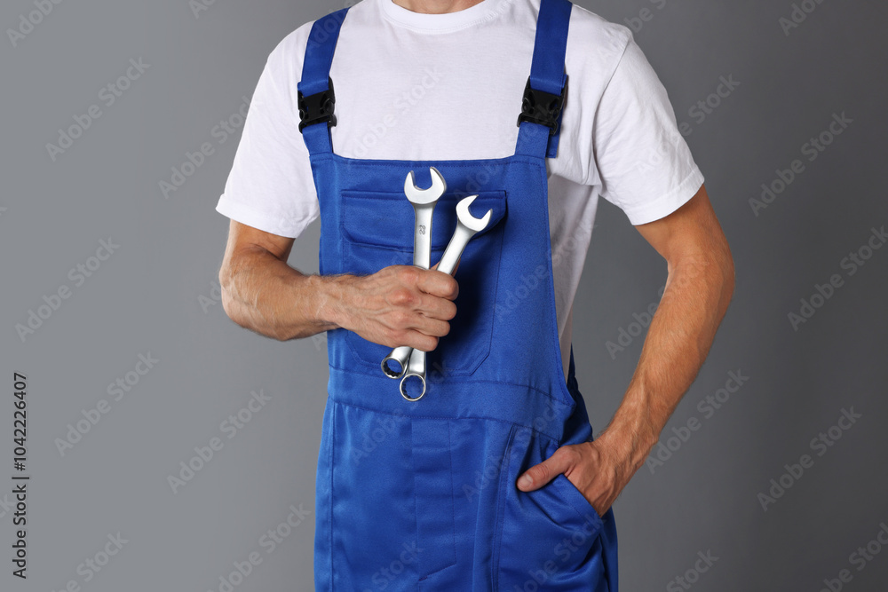 Sticker Auto mechanic with wrenches on grey background, closeup