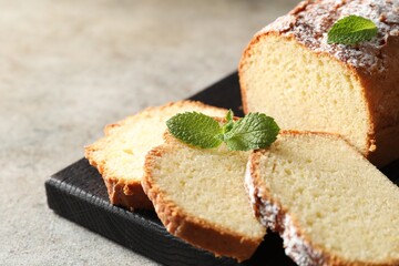 Freshly baked sponge cake on light grey table, closeup