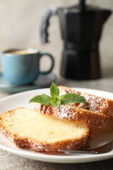 Freshly baked sponge cake and coffee on light grey table, closeup