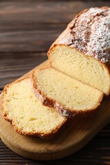 Freshly baked sponge cake on wooden table, closeup