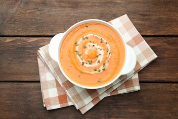 Delicious sweet potato soup with microgreens on wooden table, top view