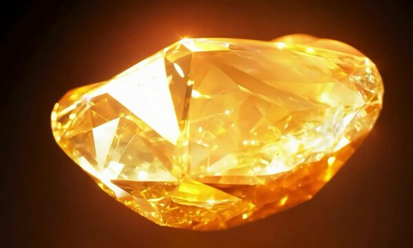 Orbit shot with warm, radiant lighting: The camera starts with an orbit around a beautiful topaz crystal, glowing warmly. The camera captures the crystal&rsquo;s golden hues and the radiant light that enhan