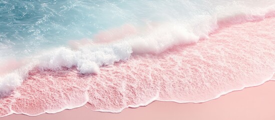 Fototapeta na wymiar White foamy waves gently crashing on the pink sand of a pristine beach.
