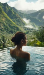 Fototapeta premium Woman in pool looking at lush mountains.