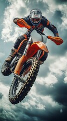 Motocross rider performing an impressive jump during a cloudy day
