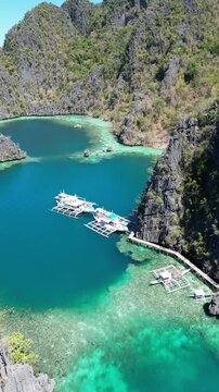 Blue Lagoon Philippines Coron Tropical Island. Crystal clear blue water, traditional Philippines fishing boat