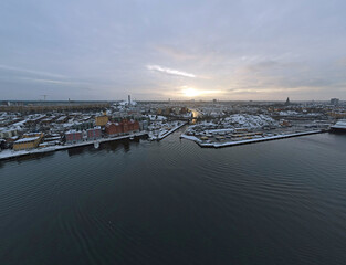 Aerial drone Landscape of colorful riverfront buildings during snowy winter Central Stockholm Sweden