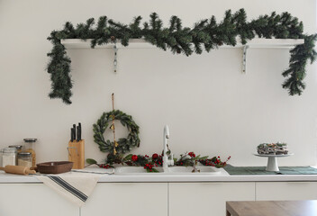 Interior of light kitchen decorated for Christmas
